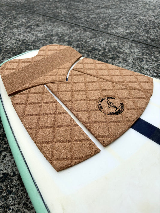 Natural cork surfboard tail pad with 3M adhesive backing" and "Sustainable surfboard traction pad for high-performance surfing Australia