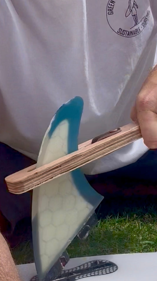 The FinEase wooden surfboard fin puller tool with leather protection strip