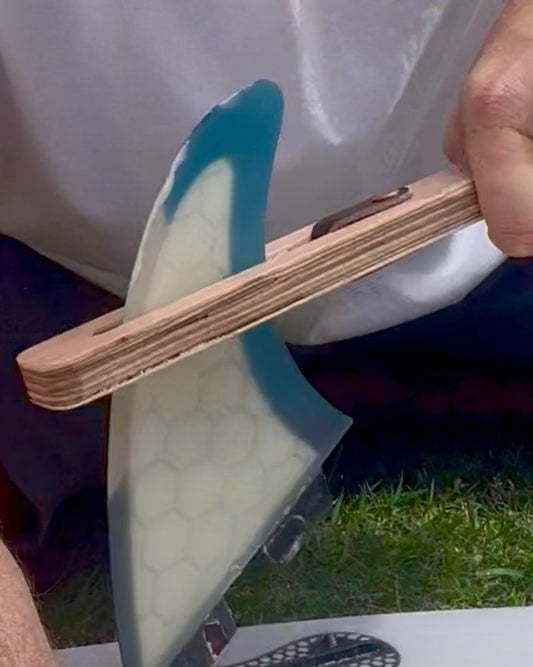 The FinEase Wooden surfboard fin puller tool with leather protection strip