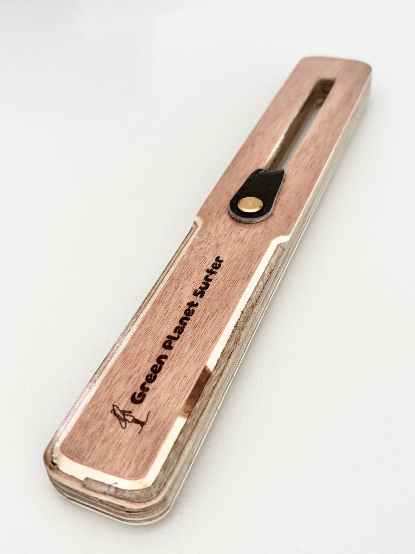The FinEase wooden surfboard fin puller tool with leather protection strip