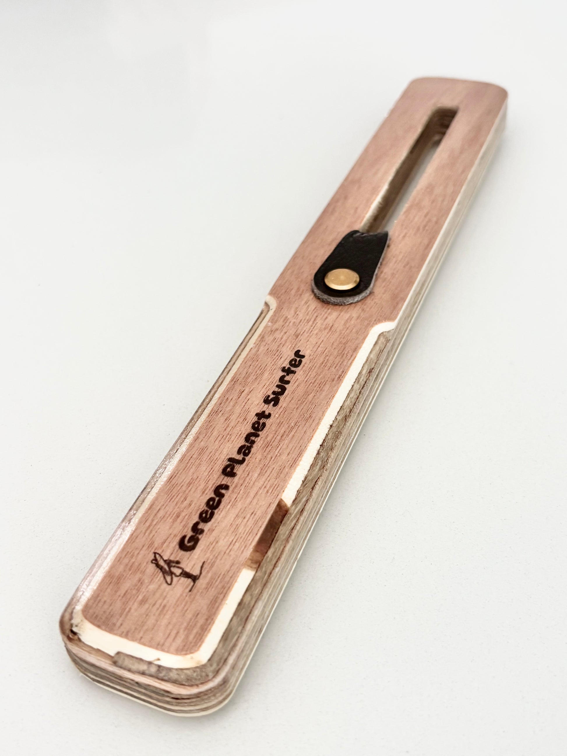 The FinEase wooden surfboard fin puller tool with leather protection strip