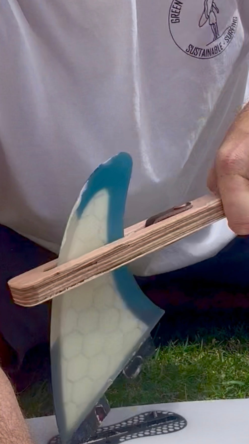 The FinEase wooden surfboard fin puller tool with leather protection strip