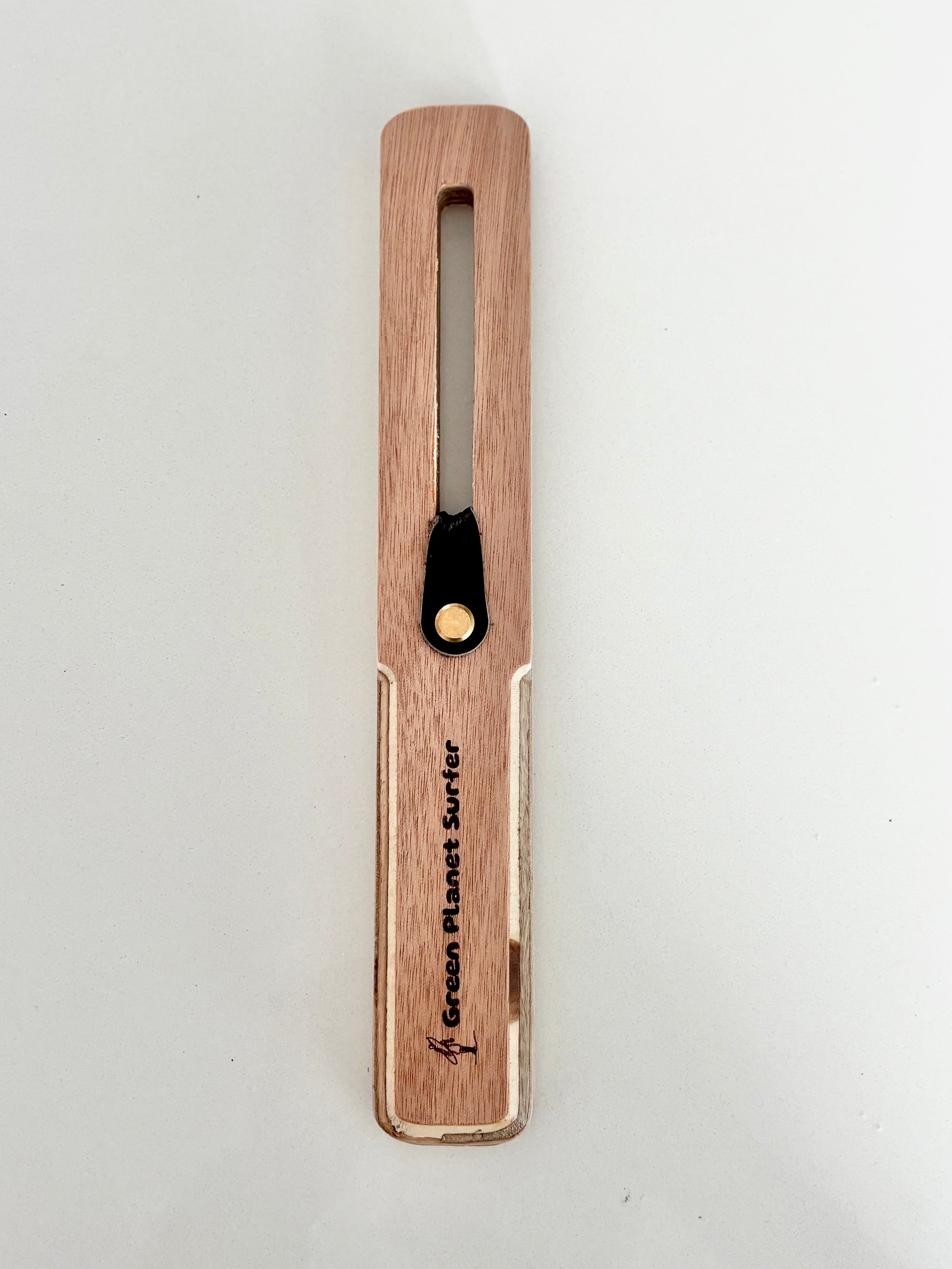 The FinEase wooden surfboard fin puller tool with leather protection strip
